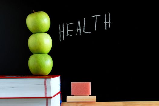 apples books and chalkboard showing healthy lifestyle