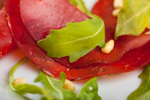 closeup of a ham sandwich with rocket salad