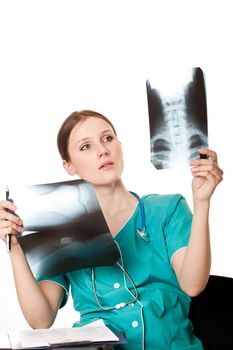 Young female doctor looking at the xray pictures