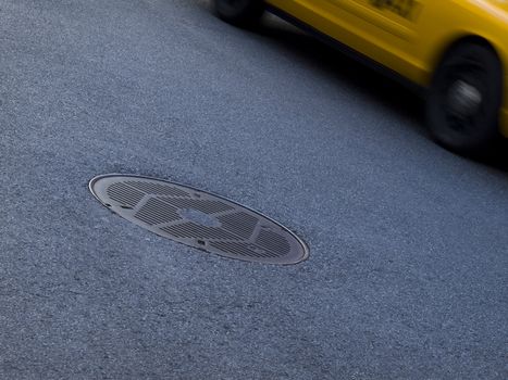 A New York yellow cab running beside a culvert.