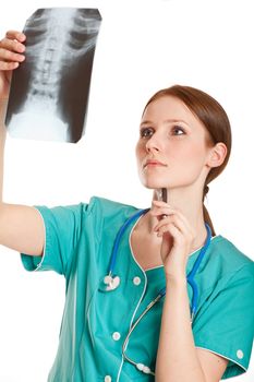 Female doctor in the green uniform looking at the xray picture