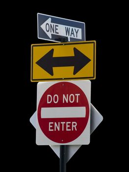 Three street signs over a black background.