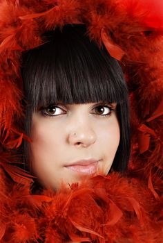 portrait of pretty teen girl with red feather boa