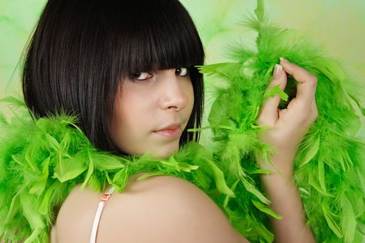 portrait of pretty teen girl with green feather boa