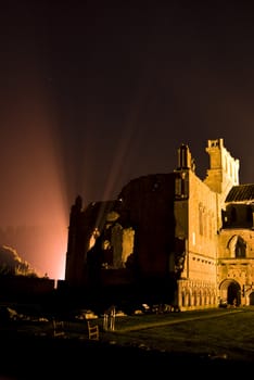 ruin of Melrose Abbey illuminated at night