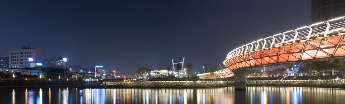 City night scenic of panorama with buildings and color bridge in Kaohsiung, Taiwan.