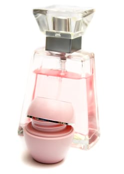 Perfume and cream of pink color. Isolation on a white background. Shallow DOF