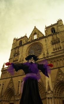 Witch figure outside cathedral in Lyon France during summer festival