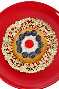 blueberry and cherry shortcake on red plate