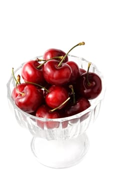 cherries in a glass bowl, isolated on white