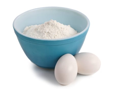 blue bowl filled with flour and eggs, isolated on white
