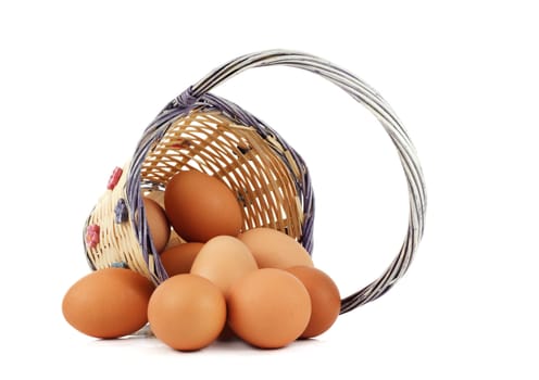 fresh whole brown eggs on wicker basket, white background