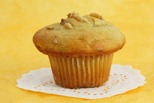 muffin on white paper, yellow background