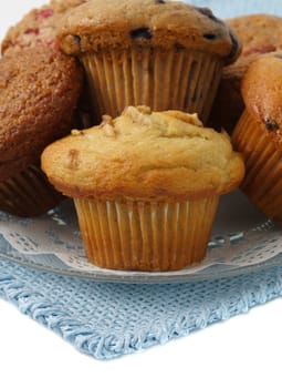 variety of muffins on a plate, bleu tablecloth
