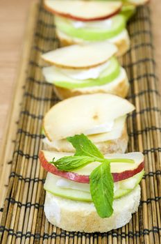 canapes row, melting brie cheese and fresh organic fruits