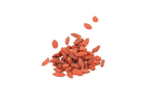 Pile of red dry goji berries on a reflective white background