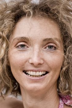 Face Closeup Of A Mature Blond Curly Woman