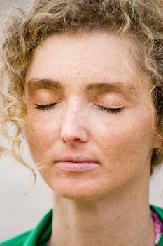 Blond Mature Woman With Curly Hair Closeup Portrait When Meditating