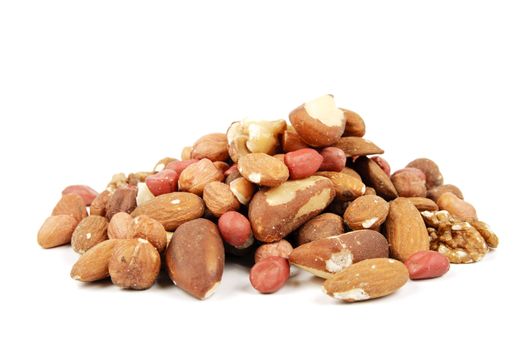 Assorted mixed nuts on a reflective white background