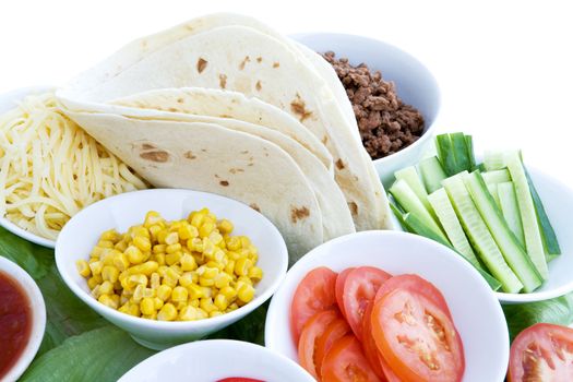 A layout of taco ingredients isolated on white