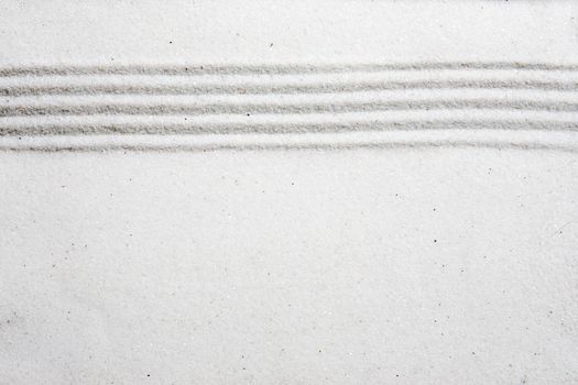 A background image with white sand and a raked stripe