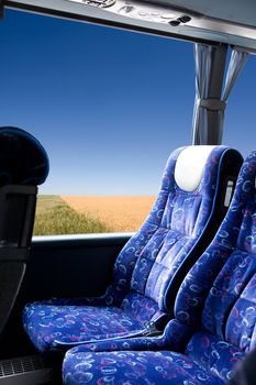 A prairie view from a bus