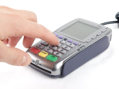 Payment terminal with keypad and a finger pressing entering the PIN code