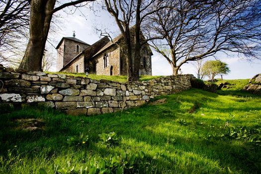 A stone church on a green meadow