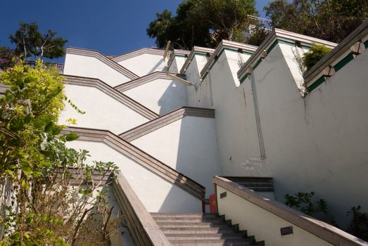 Street with stairs in outdoor with white color under blue sky. Famous landmark in Kaohsiung, Taiwan.