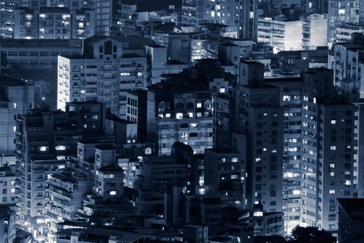 Night scene of buildings illuminated in modern city.