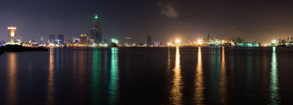 Panorama harbor scenic of city in night with light reflection on ocean in Kaohsiung, Taiwan.