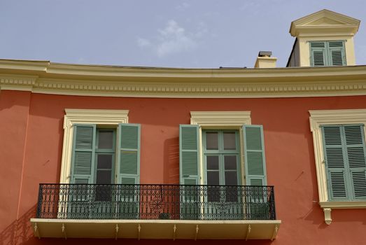 Street view of a typical pastel colored house at the Cote Azur with mediterranean appeal.