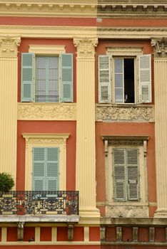 Street view of "old and new" at a pastel colored house at the Cote Azur.