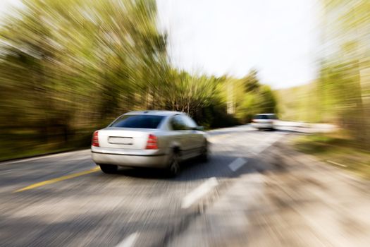 A motion blur image of a speeding car