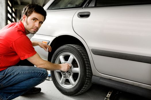 Taking off the bolts on a car tire