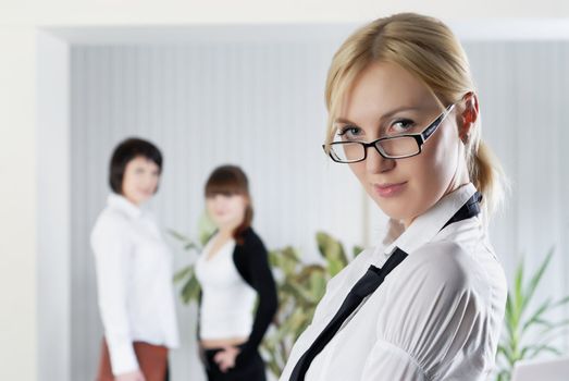  The young business woman at office with colleagues 

