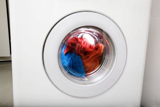 Washing machine detail with colorful clothes