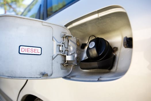 A diesel tank on a car open and ready for filling