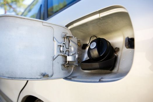 A fuel tank on a car open and ready for filling