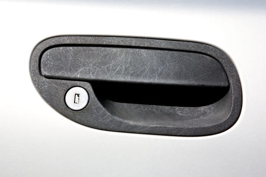 An old car door handle in black