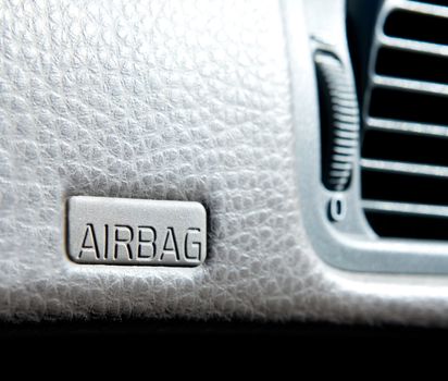 An airbag sign in a car on the dash