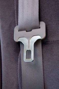A seatbelt in a car with cloth seats