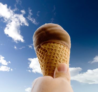 An ice cream cone isolated against a deep blue sky