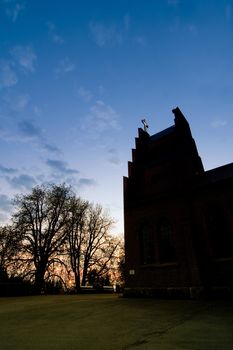 A church silhouetted against a sunset