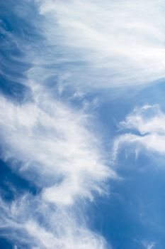 A cloud abstrct background image with whistful clouds and a deep blue sky