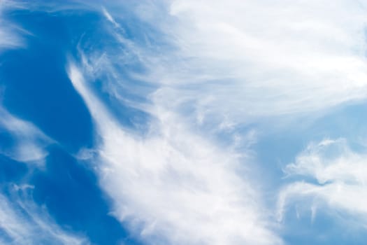 A cloud abstrct background image with whistful clouds and a deep blue sky