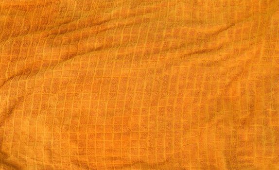 A bright orange cloth towl background texture