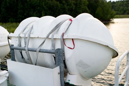 A life raft on the side of a boat ready for deployment