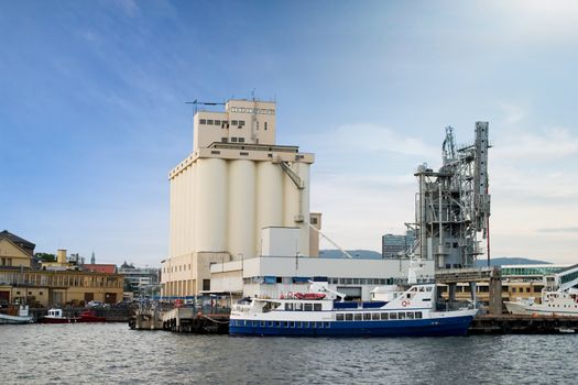 An ocean seaside port with a grain terminal and ferry