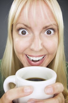 Beautiful Woman Enjoys Her Coffee Against a Grey Background.